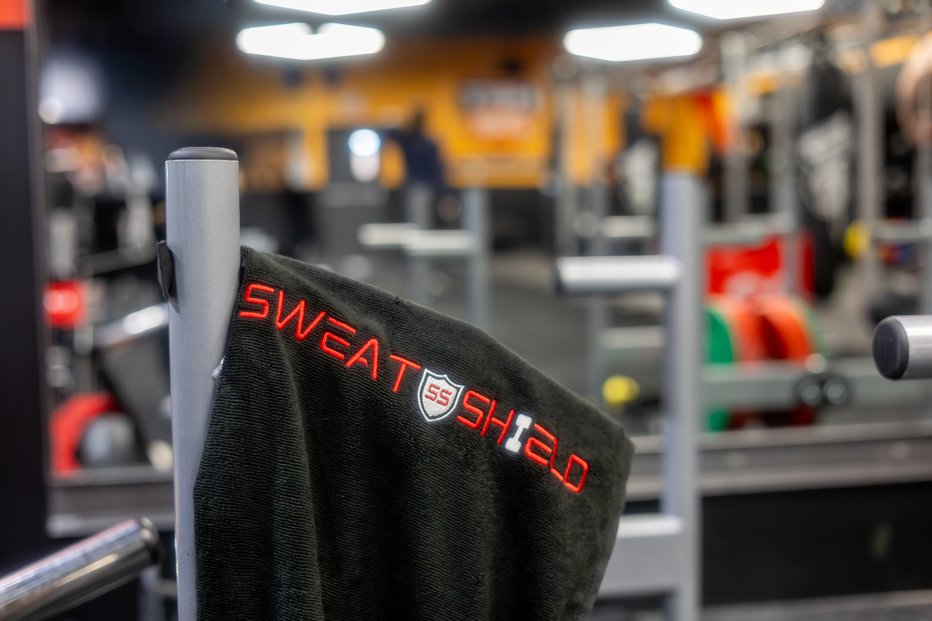 SweatShield premium black gym towel with red embroidered logo
