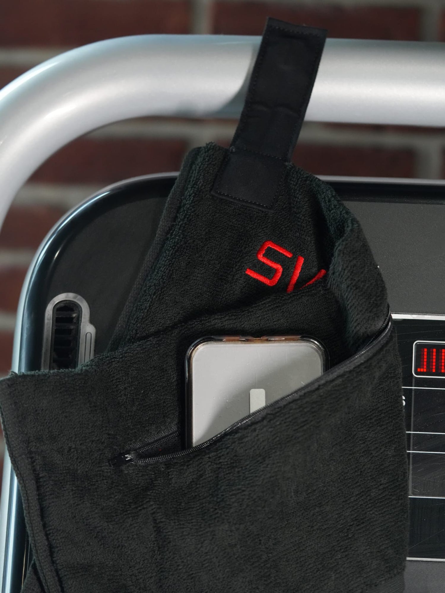 Zipper pocket holding phone and magnet strap