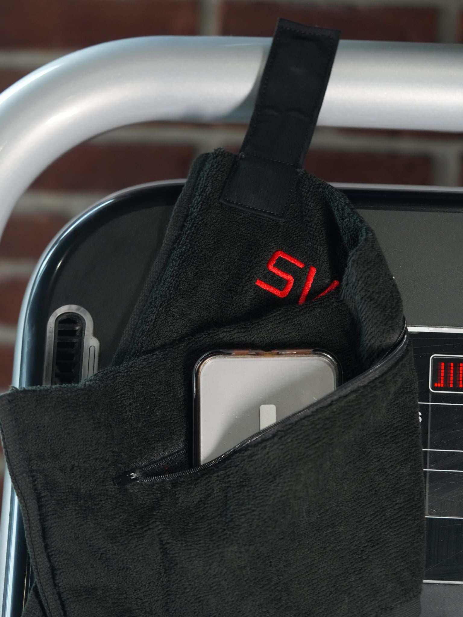 Zipper pocket holding phone and magnet strap